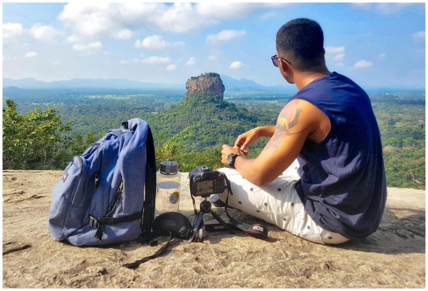 A man enjoys the scenic view of Sigiriya Rock in S