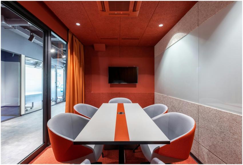 Stylish modern meeting room with orange accents, g