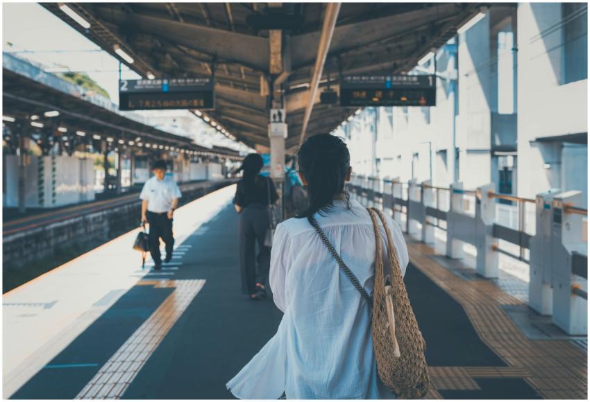 People walking on a platform in a Tokyo train stat