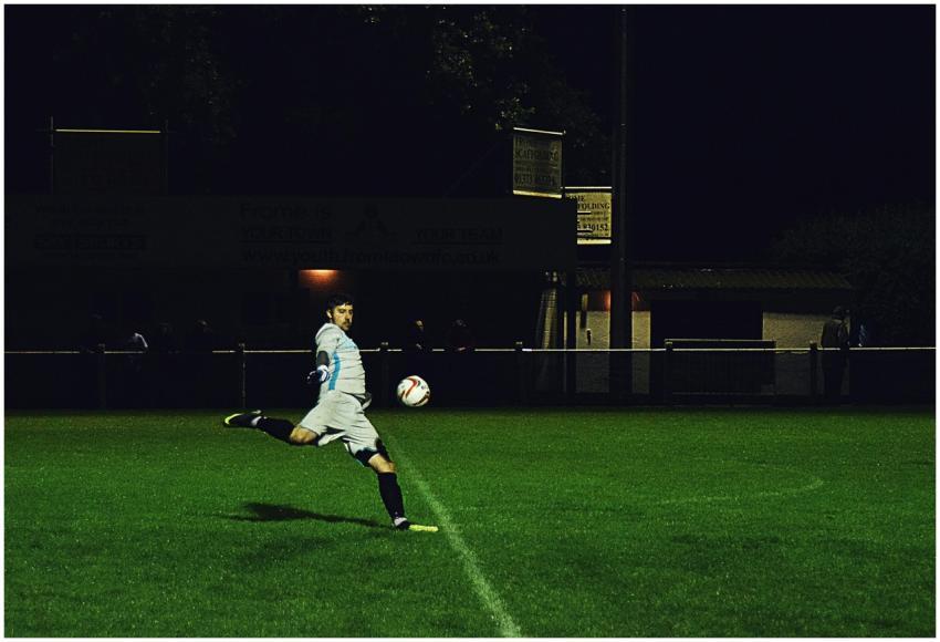 Dynamic action shot of a soccer player kicking the