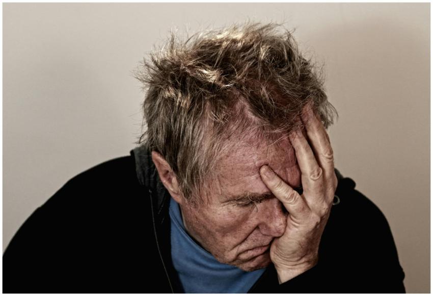 Portrait of an elderly man feeling stress and disa