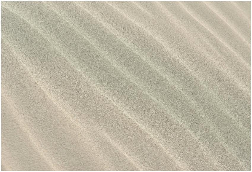 Close-up view of textured sand dunes with soft rip