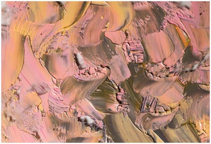 Close-up of textured paint swirls in pink and peac