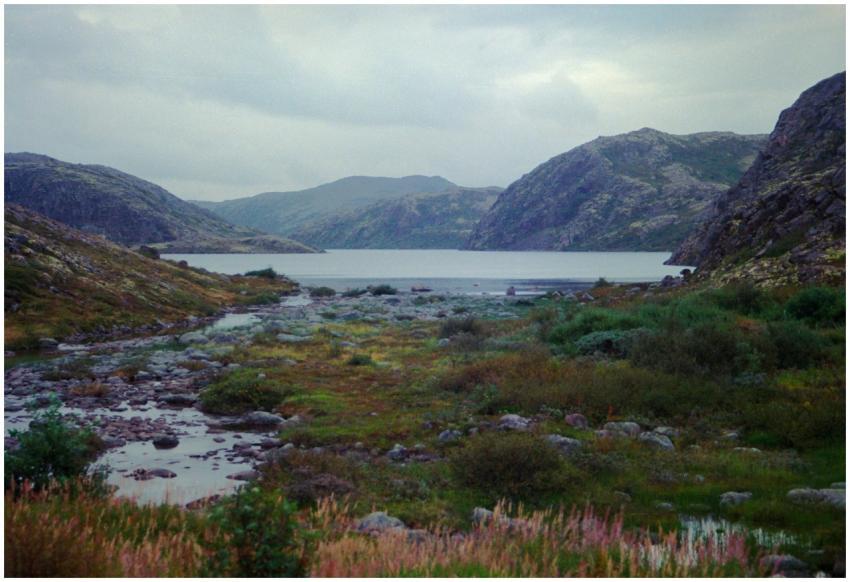 A tranquil scene of rocky hills and a serene lake