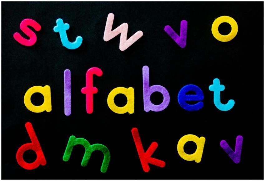 Vividly colored alphabet letters arranged on a bla