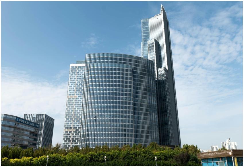 A sleek, modern skyscraper stands tall against a b