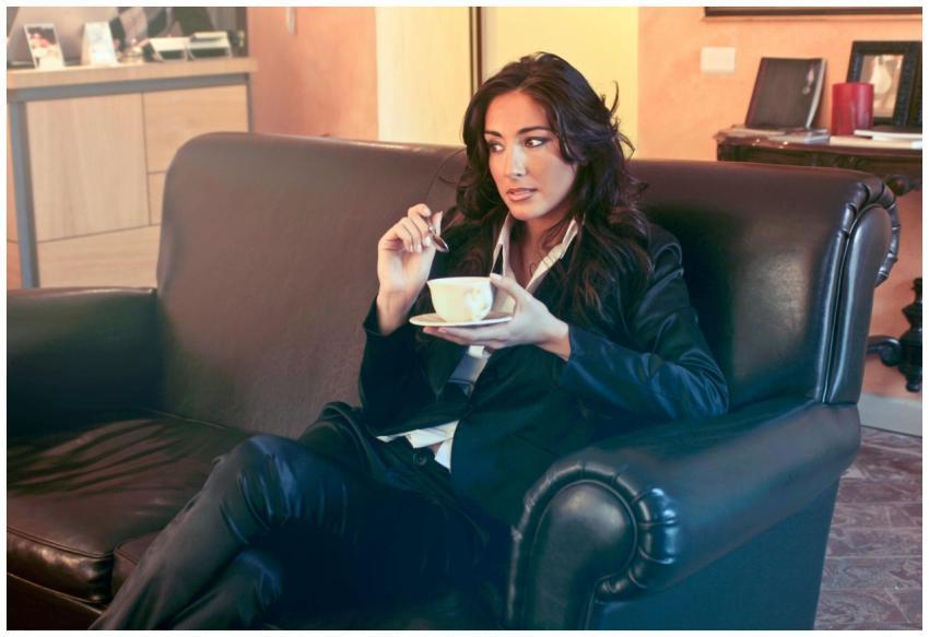 Stylish businesswoman enjoying a coffee break in a
