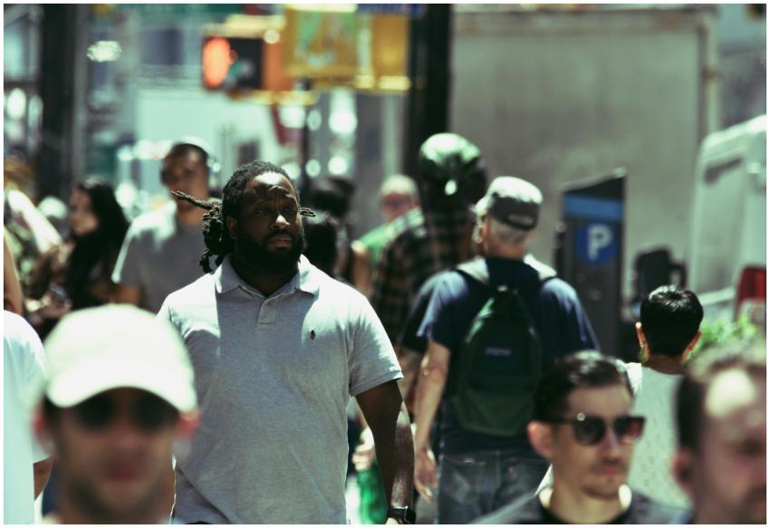 A bustling city street scene with diverse people w