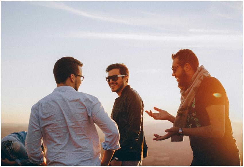 Group of male friends laughing together outdoors d