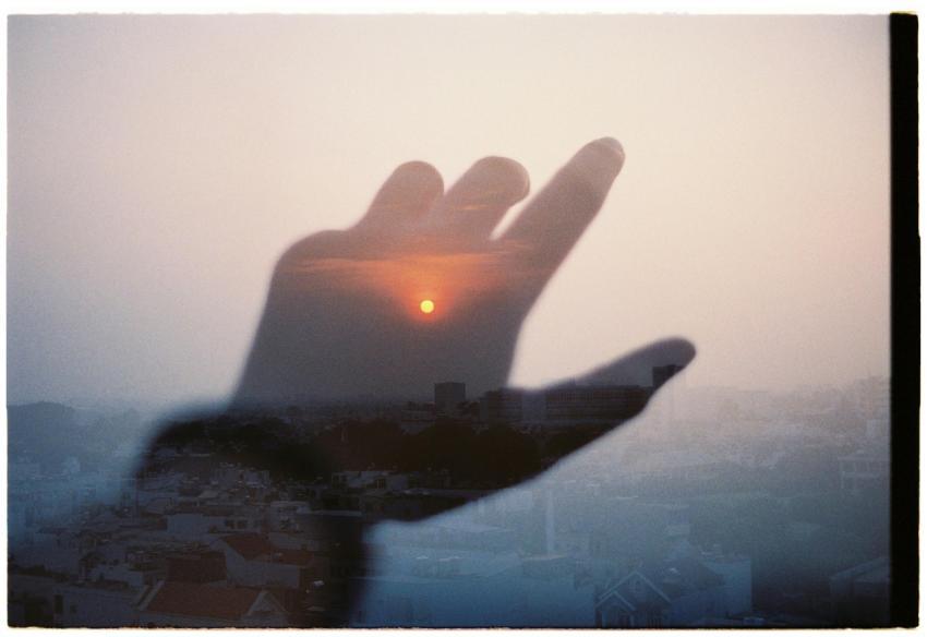 A creative montage blending a hand with a cityscap