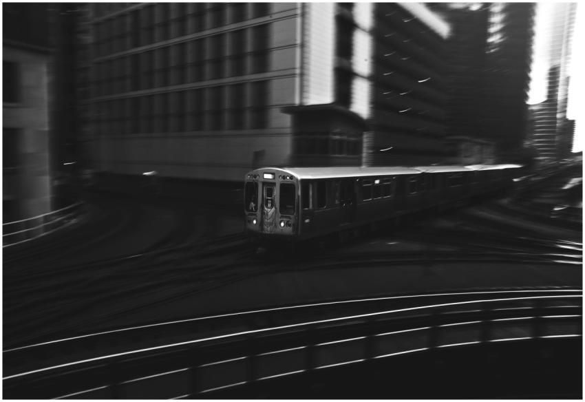 Dynamic black and white photo of a train navigatin