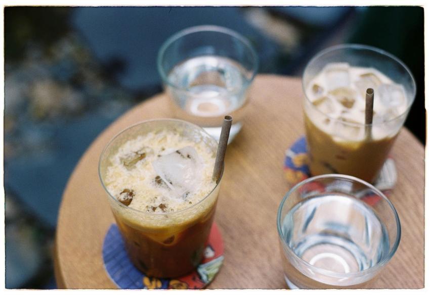 Top view of Vietnamese iced coffee and water glass