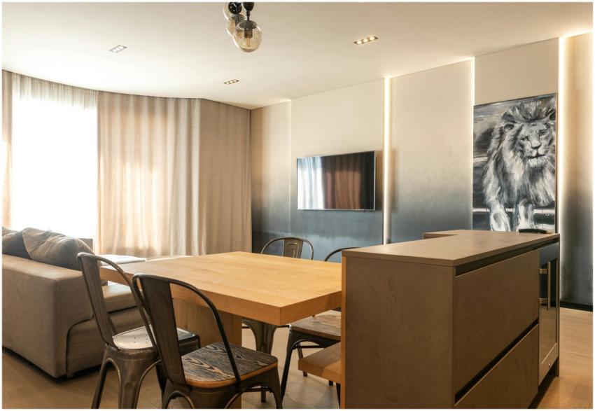 Wooden table with chairs placed in spacious living