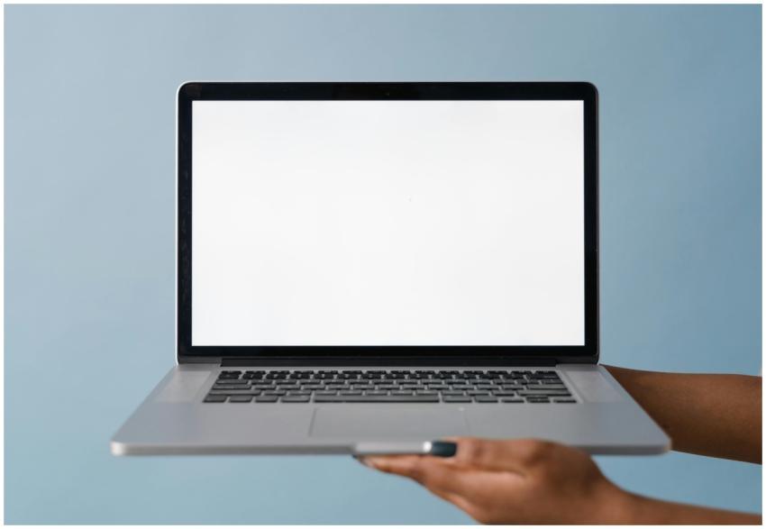 Close-up of a laptop held by a hand, perfect for t