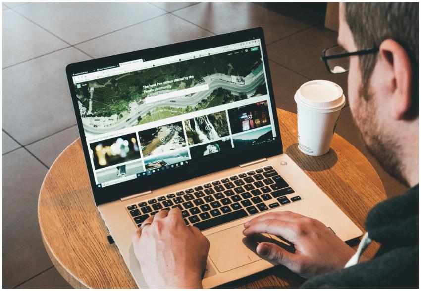 Man working on a laptop in a modern workspace with