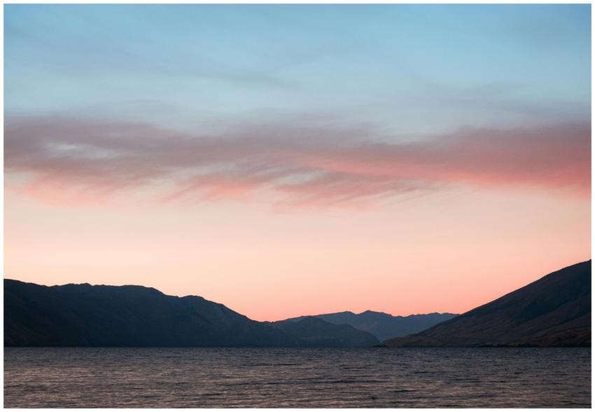 A serene landscape featuring a pastel sunset above