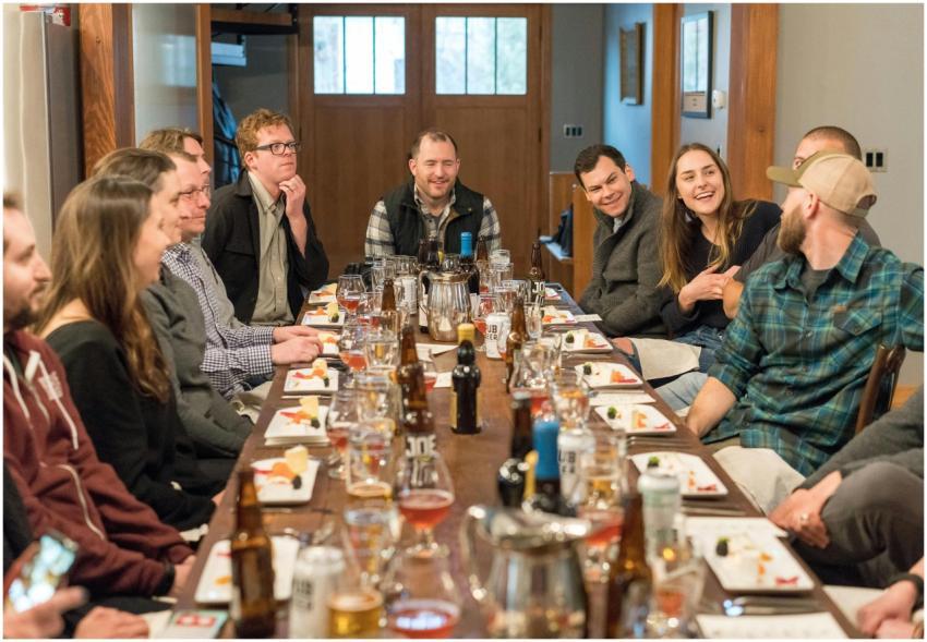 A joyful group of adults enjoying a meal and drink