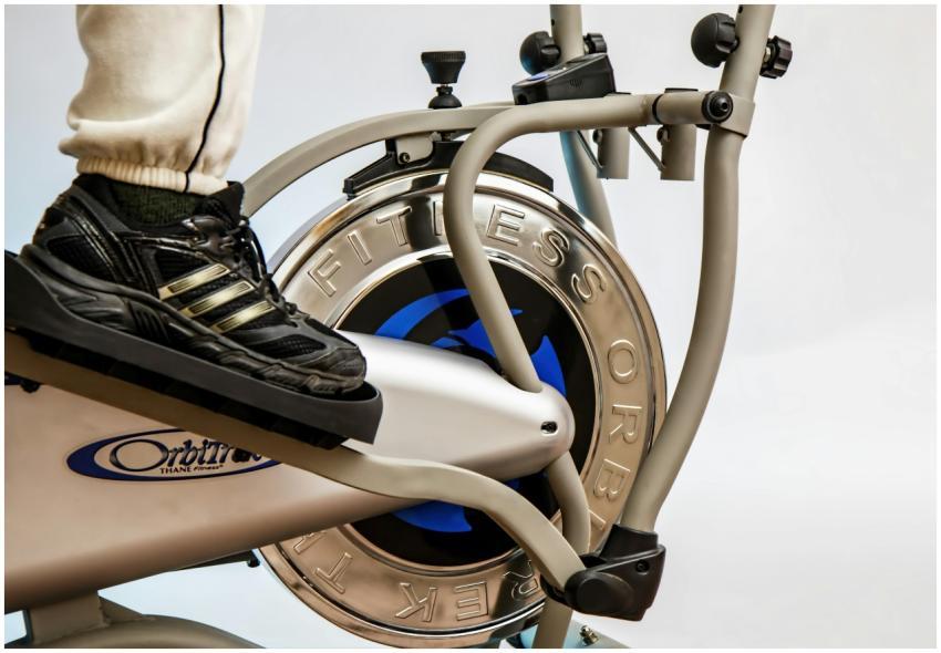 Foot on pedal of elliptical trainer showcasing fit