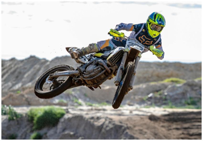 A motocross rider performs an impressive jump at a