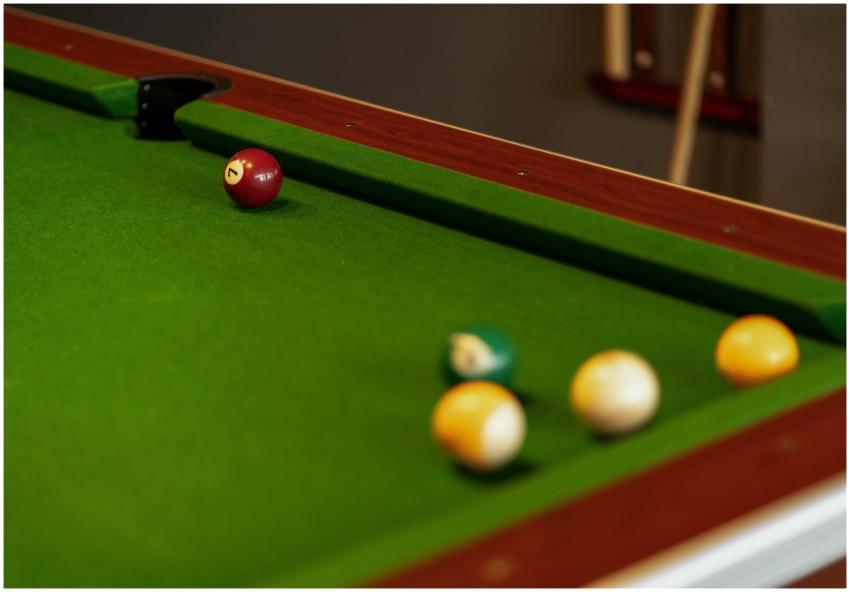 A close-up view of billiard balls on a green snook