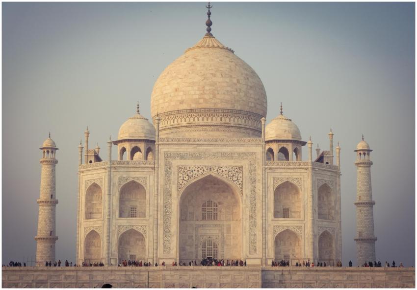 Facade of white Taj Mahal mosque with huge dome an