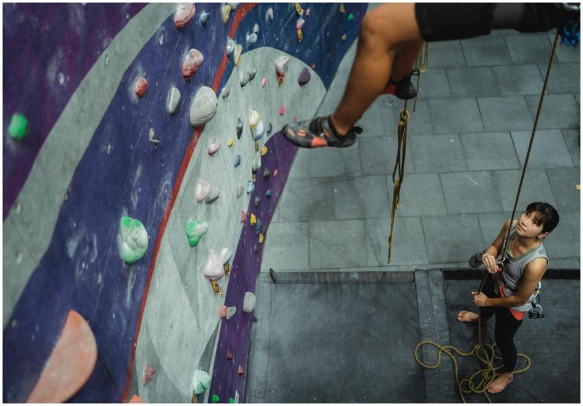 Concentrated Asian female athlete in sportswear ho