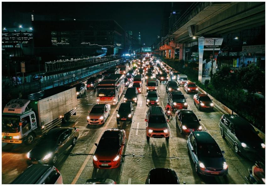 A bustling urban highway filled with cars and buse