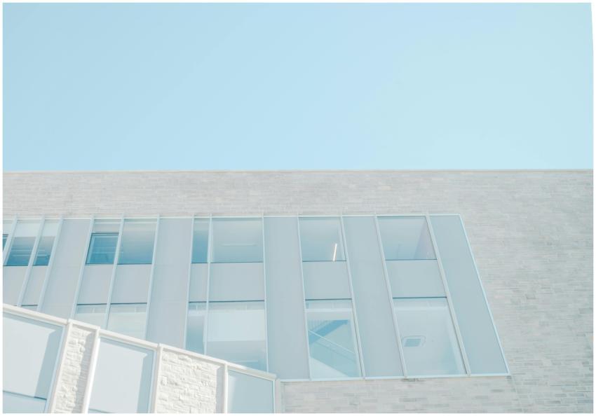 Low angle view of a modern glass facade against a