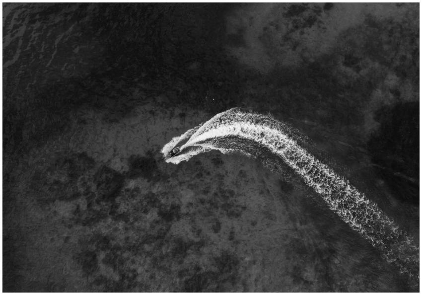 Aerial view of a motorboat creating a wake in the