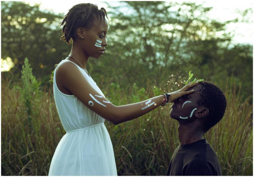 A young African couple with face paint sharing an