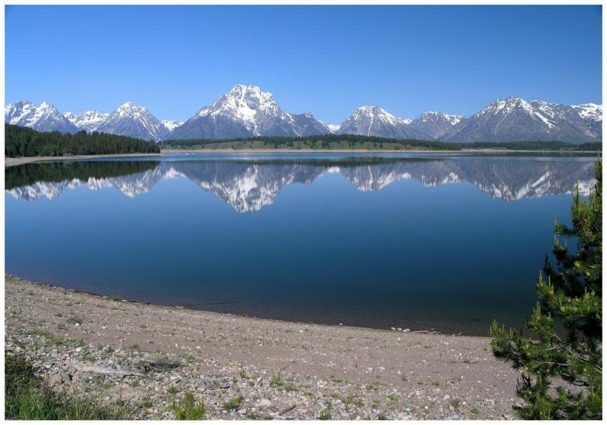 Stunning reflection of snow-capped mountains in a
