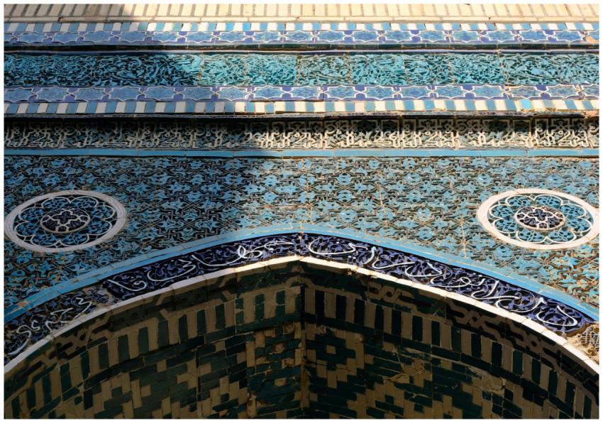 Intricate blue mosaic tilework on an ancient Islam