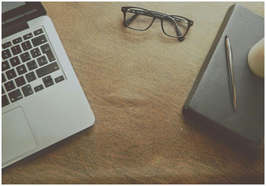 A well-organized workspace featuring a laptop, not