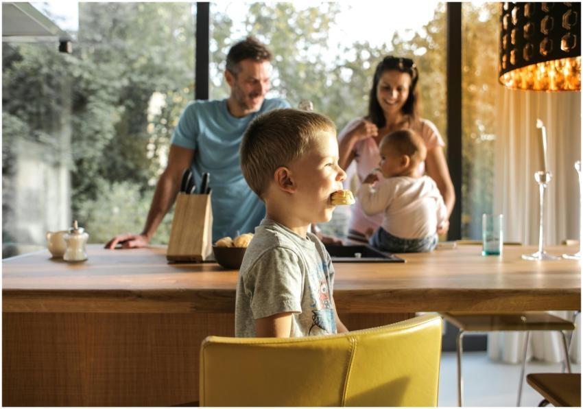 A joyful family gathers in a bright kitchen, enjoy
