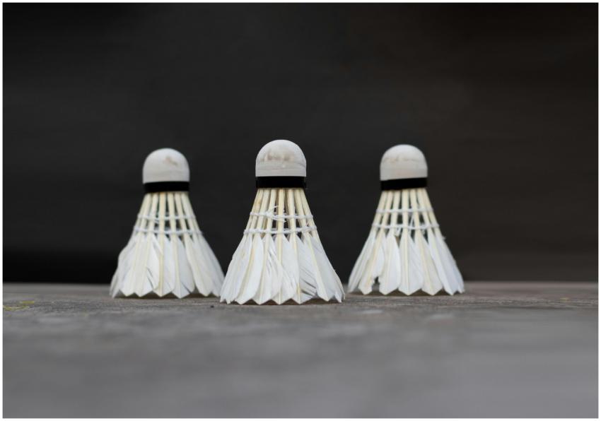 A detailed view of three white badminton shuttleco