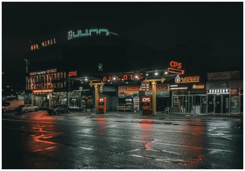 Vibrant city scene showcasing a gas station at nig