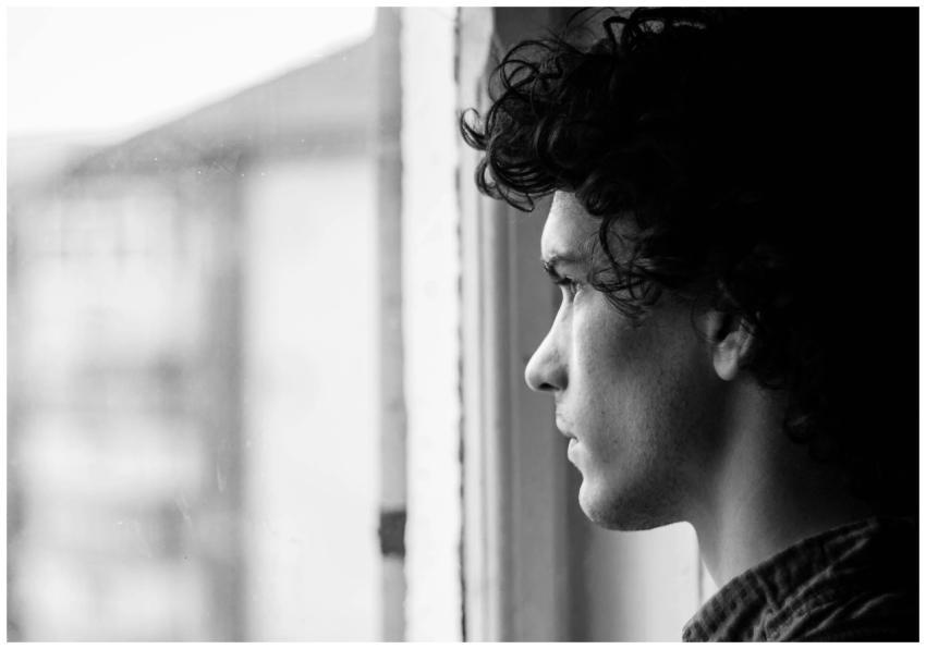 Profile portrait of a young man looking thoughtful
