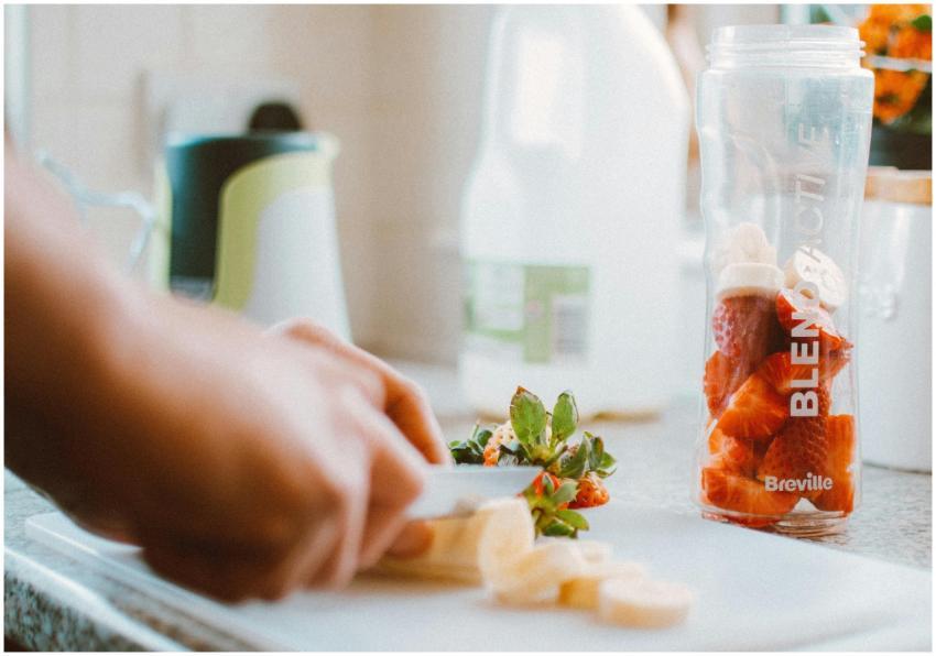 Close-up of hands slicing fruits for a nutritious