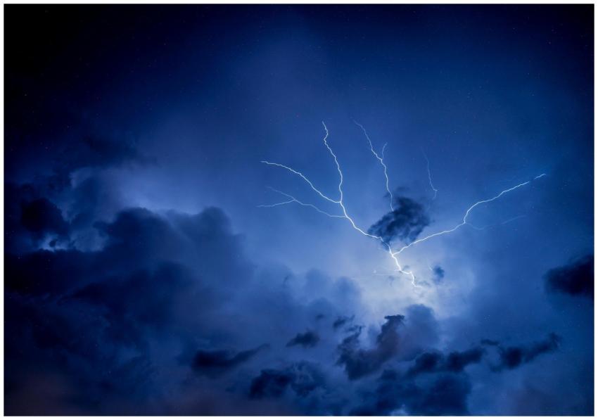 Dramatic lightning strike illuminating a dark, ove