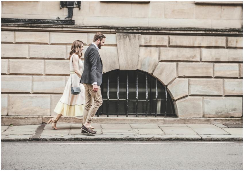 Elegant couple walking together on a city sidewalk