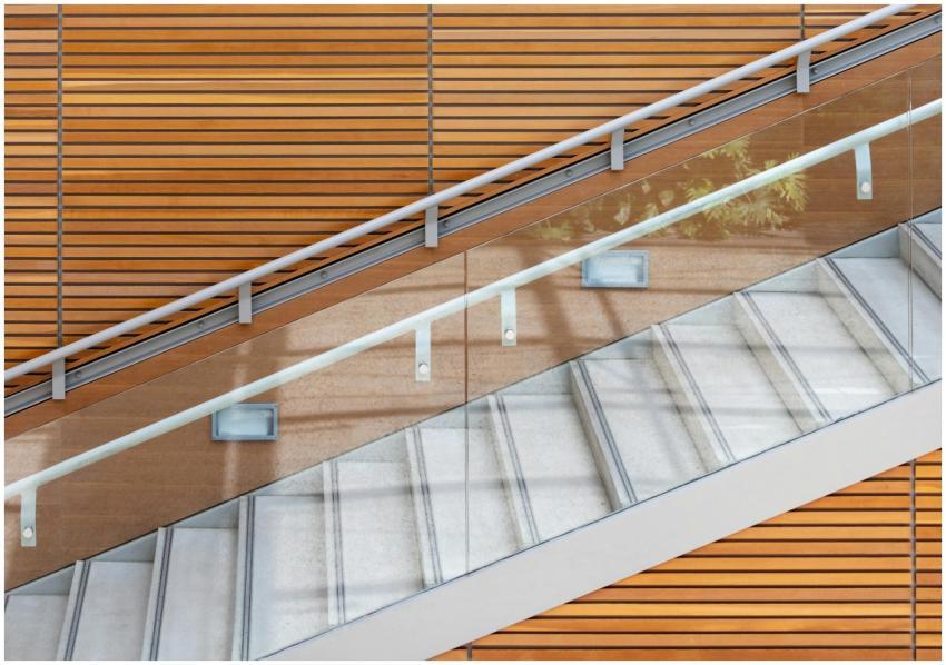 A contemporary staircase featuring glass railings