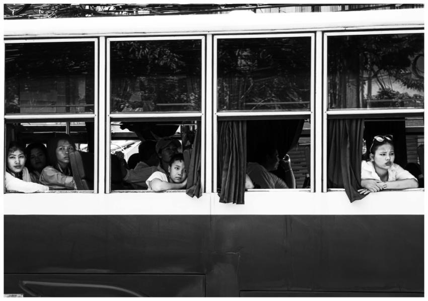 Monochrome photo of people on a bus in Thailand, s