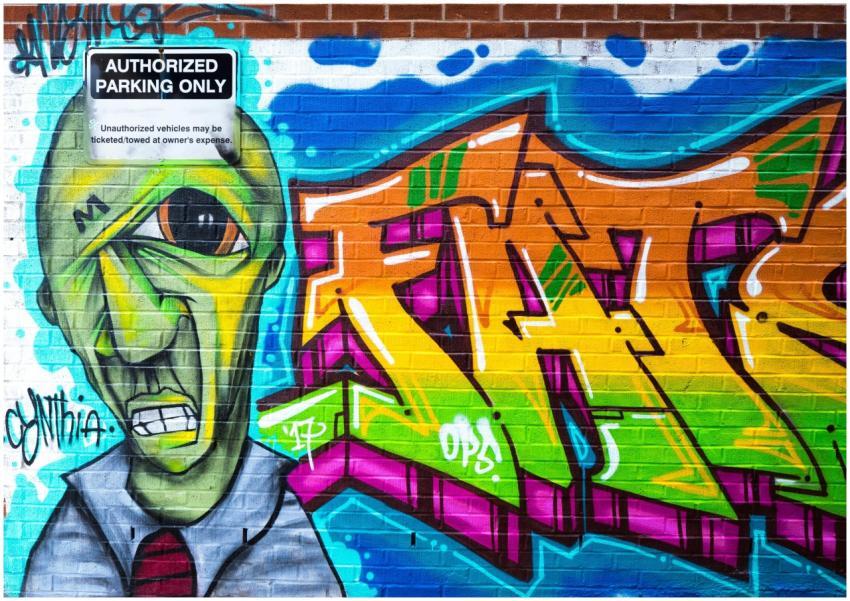 Colorful graffiti art on a brick wall in London, O