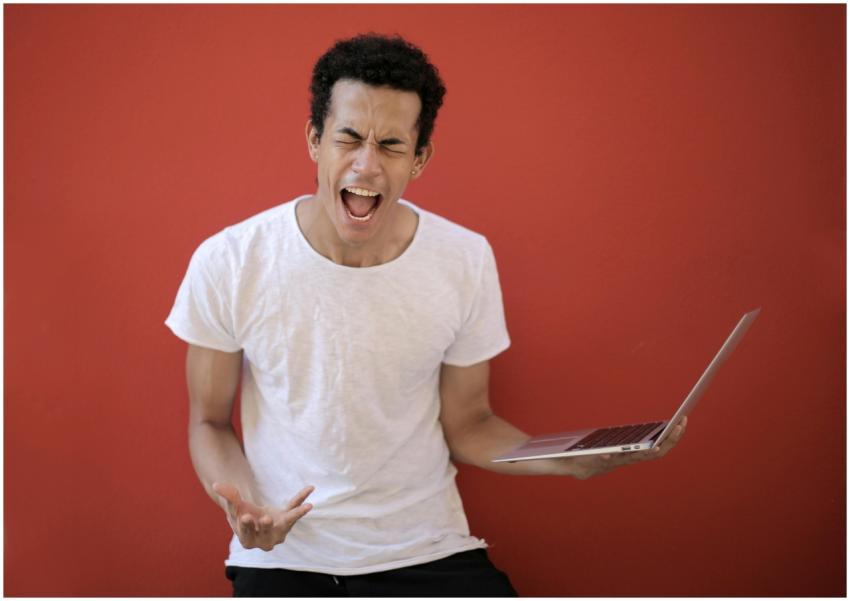 Guy with opened mouth and closed eyes screaming ma