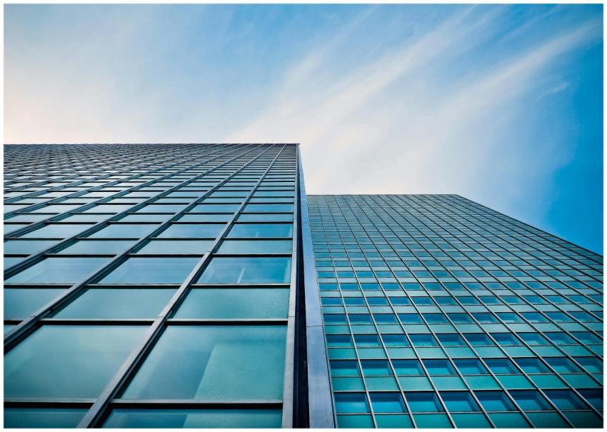 A low angle view of a modern glass skyscraper agai