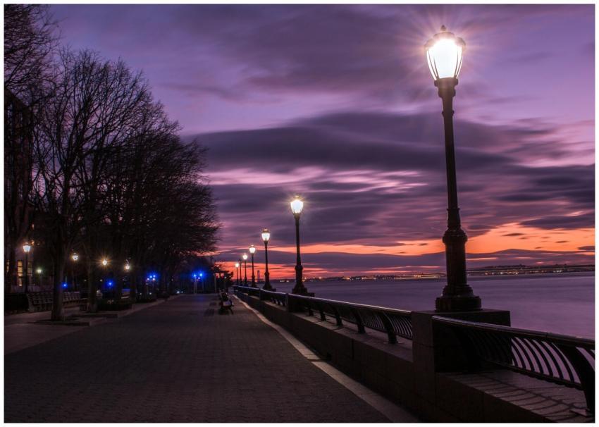 Dusk view of lamppost-lit path by the river at Rob