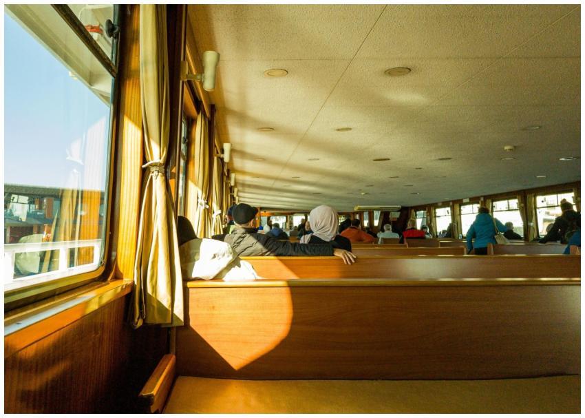 Passengers enjoy a peaceful boat ride in sunny wea