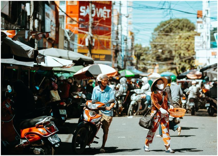 Vibrant outdoor market scene with people and scoot