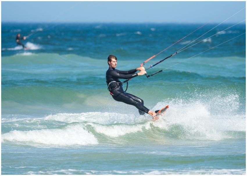 A skilled kiteboarder navigates thrilling waves on