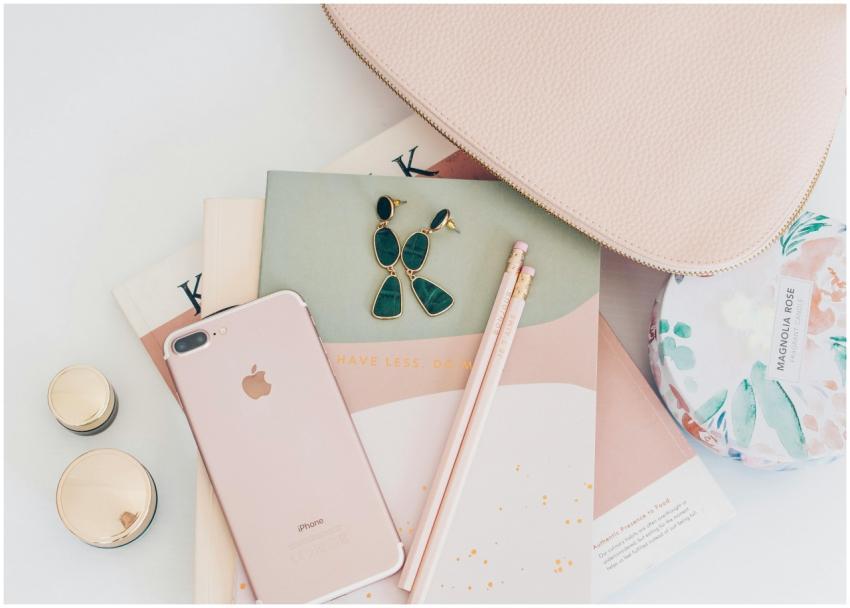 A stylish flatlay featuring rose gold accessories,